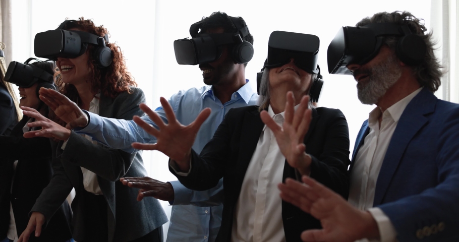 Multiracial teamwork having fun wearing virtual reality headset inside business office | Shutterstock HD Video #1088651279