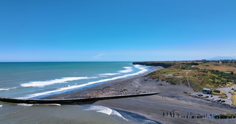 Summer day flight across Mana Bay's black sand beach - Taranaki New Zealand