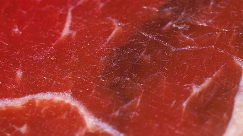 Macro shot of dry or smoked red meat, detailed texture in 4k. Close up view.
