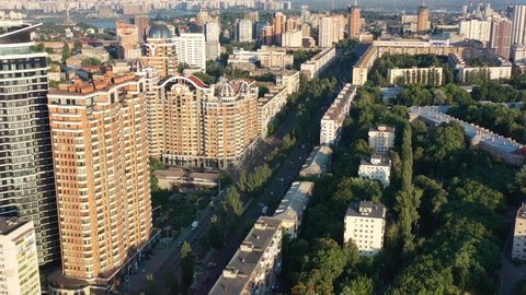 Aerial drone video of downtown apartment buildings and cars on the highway in Pecherskyi district of Kyiv Oblast Ukraine during sunset. Filmed on a summer day in August 2021