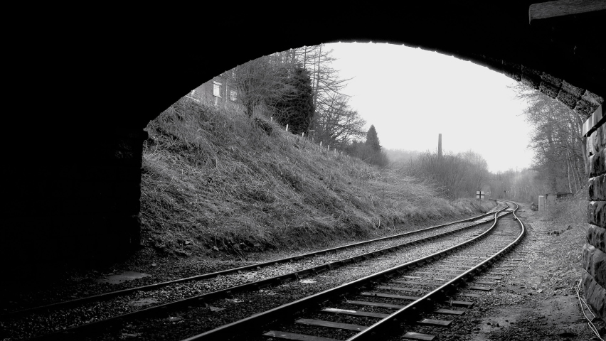 Steam train moving on track in England UK going through tunnel UK 4K