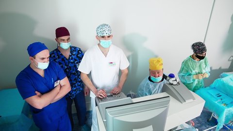 KYIV, UKRAINE - August 2021: Ophtolmology specialists working with laser correction. Eyesight laser corrective equipment.