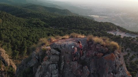 Climbing in the mountain. Drone view of climber girl and man. Physical activity in the countryside. Risky sports. Mountain climb or climbing with safety equipment in Murcia, Spain