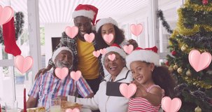 Animation of heart icons over african american family with santa hats. social media and communication interface concept digitally generated video.