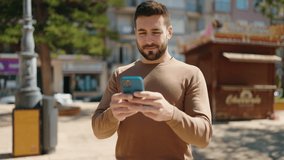 Young hispanic man smiling confident using smartphone at park - Powered by Shutterstock - Get 15% off with code: PIKWIZARD15