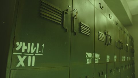 4k Close up Dolly shot of green colored metallic military Locker Room . Military dressing room , storage . Military training concept .