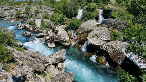 Big and fast river turning into waterfall in Podgorica. Landscapes, sights and nature of Montenegro.