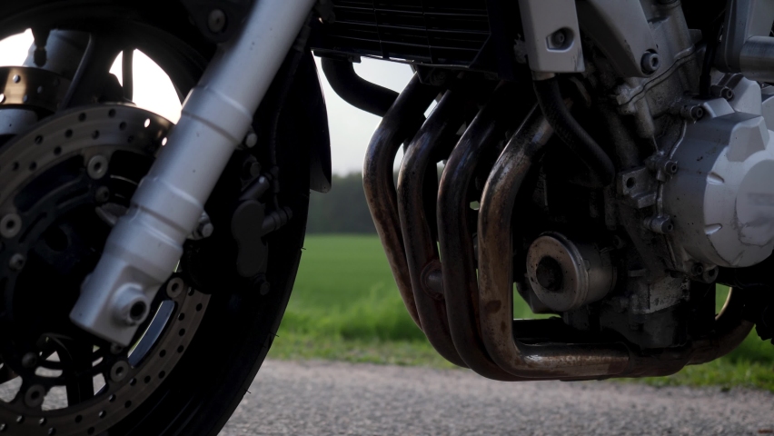 In this close up type of shot you can see elements and parts of silver street motorcycle during sunset. 4K (UHD) quality.