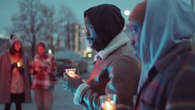 Selective focus shot of two African American men standing outdoors and holding candles in cups while gathering for candlelight vigil - Powered by Shutterstock - Get 15% off with code: PIKWIZARD15