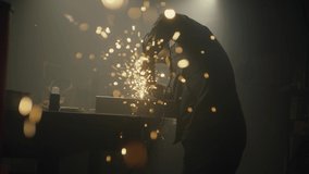 Industrial worker cutting metal with many sharp sparks. Male using special tool for cutting metal at workshop. Sparks flying from metal processing. Slow motion. 4K video. Shot on RED - Powered by Shutterstock - Get 15% off with code: PIKWIZARD15