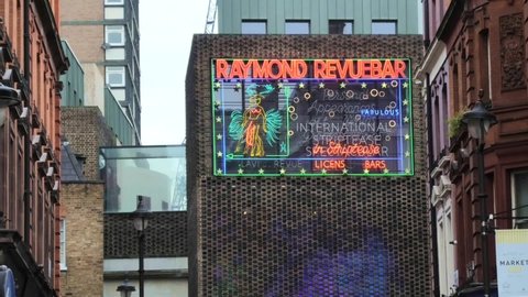 Raymond Revuebar adult entertainment sign looking up Rupert Street in the Soho area of London. London - 14th November 2020