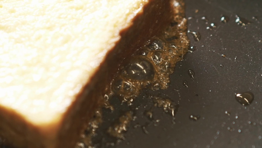 French toast being fried in ghee and sugar in a non-stick pan. Top view shot of cooking process. Easy breakfast recipe from bread. Sweet Snack 
Close up shot of sugar bubbles burst in slow motion | Shutterstock HD Video #1088684291