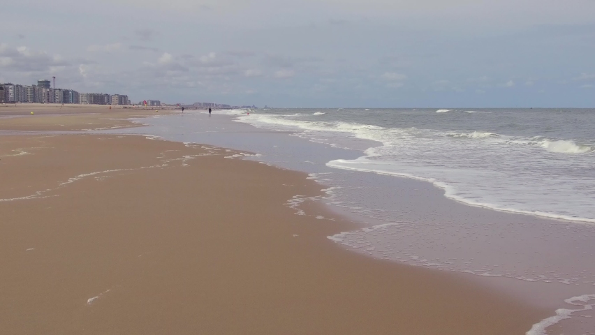 Sandy beach of Ostend in a stormy summer day.