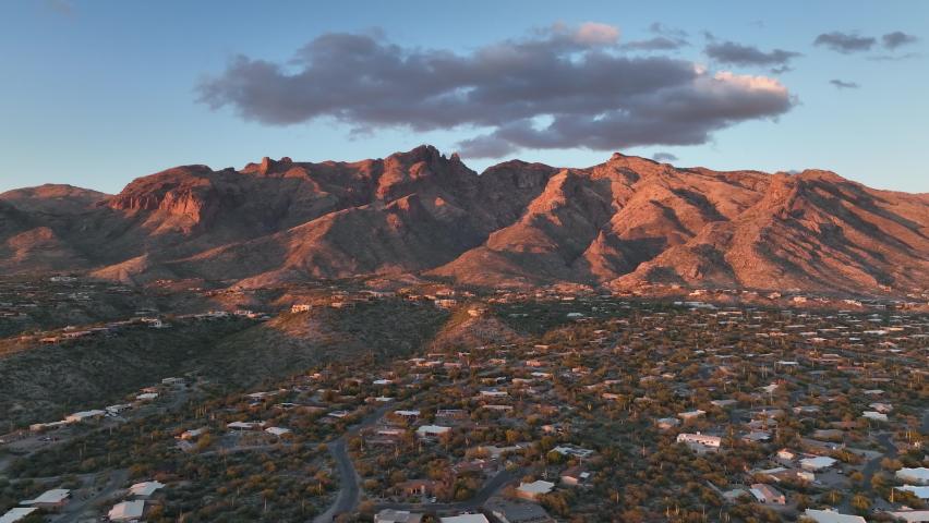 Cinematic drone at twilight of Tuscon Arizona with mountains in the background