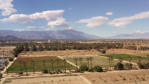 Drone view of Coachella Valley California with date palm trees and San Jacinto Mountains in distance