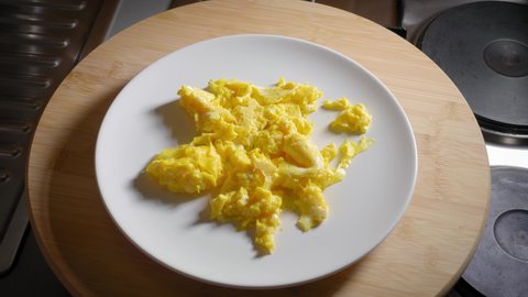 Person is Serving a Plate With Scrambled Eggs, Then Ring the Plate