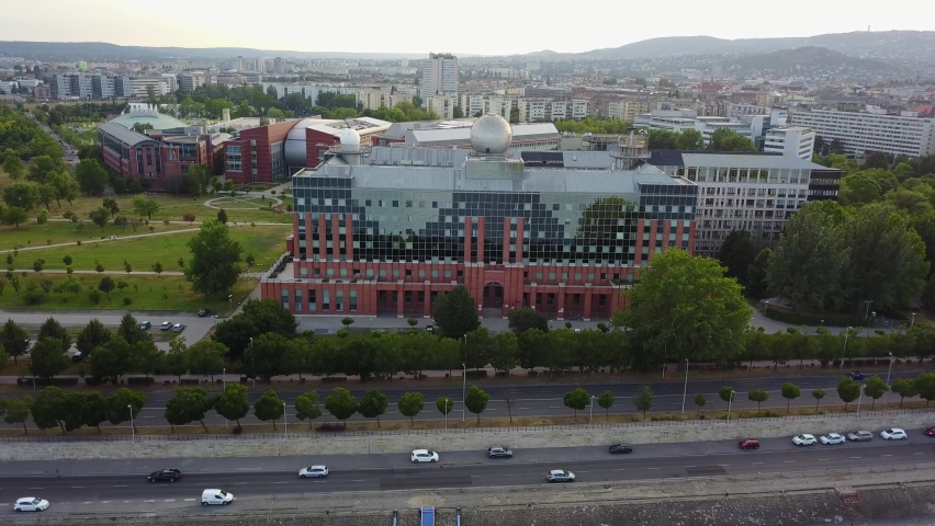 Cinematic 4K aerial drone orbit shot of Lágymányosi ELTE Campus Southern Block, University of Technology and Economics, Kopaszi-gát by the Danube river in Budapest, Hungary