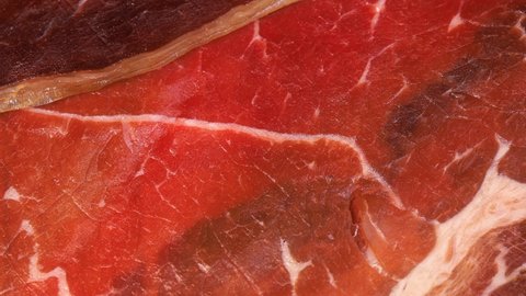 Close up view of dry or smoked red meat, detailed texture in 4k. Macro shot.