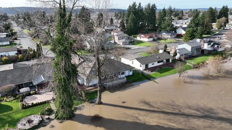 Cinematic 4K aerial drone pan shot of flooding near residential homes on the Duwamish, Green River in Auburn, King County Washington