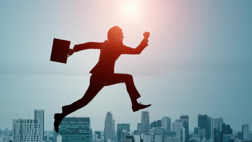 Businessman jumping in front of the city. Success of business. Royalty-Free Stock Footage #1088692437