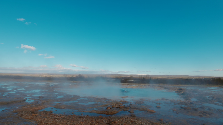 Geyser of Haukadalur in Iceland blowing-up erupting geothermal hot springs slow motion footage. Wide angle shot. High quality 4k footage Royalty-Free Stock Footage #1088694539