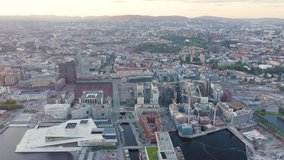 Inscription on video. Oslo, Norway. Panoramic view of the city center during sunset. Railway station. Text furry, Aerial View, Point of interest