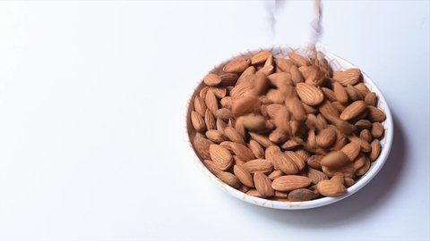 Nut almond close up in bowl. product rich in minerals and vitamins. Almond turns in a shot. Almond kernels rotating. slow motion.
