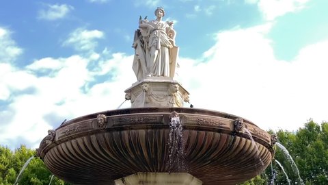 Aix-en-Provence, France - August 2021 : Fontaine de la Rotonde fountain in Aix en Provence, France with water flowing in slow motion