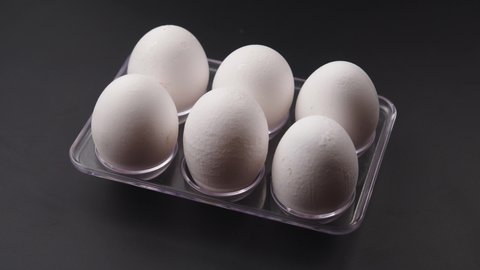 Close up Eggs in a cardboard box, Chicken white fresh, organic raw eggs in an egg container. Rotation shot