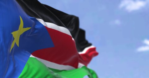 Detail of the national flag of South Sudan waving in the wind on a clear day. South Sudan is a landlocked country in central Africa. Selective focus. Seamless loop in slow motion