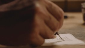 Closeup hand of man writing calligraphy with ink pen . Professional calligrapher painting , drawing on vintage paper . Beautiful handwriting . Poet writes letter , poem . Art of penmanship Slow motion - Powered by Shutterstock - Get 15% off with code: PIKWIZARD15