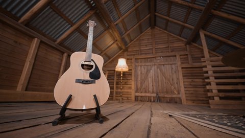 A western acoustic guitar in a guitar stand. Dolly shot. Wooden walls as background.