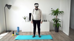 Bearded man wearing VR glasses headset and doing yoga at home. Enjoy immersive futuristic sporty lifestyle virtual reality. Augmented reality, smart fitness and innovation concept.