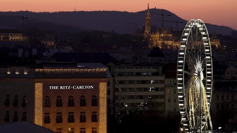 Budapest, Hungary - March 20, 2022: beautiful and special view of the city in the evening, The Ritz-Carlton Hotel, the Budapest Eye is illuminated. 
