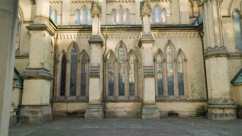 Stained Glass window bays and structural masonry buttress of Gothic Cathedral from the Exterior