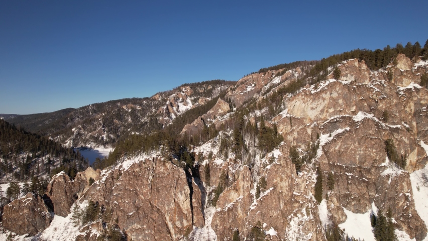 Winter landscape view of the frozen river in the national park, shot from the air