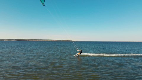 aerial view active man kiteboarding and windsurfing in slow motion, active lifestyle extreme sport concept