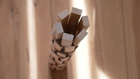 Destruction of a tower built of many wooden blocks