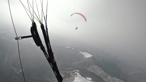 Paraglider fly in misty clouds in to the sun sky. Dream flight paragliding extreme sport adrenaline adventure