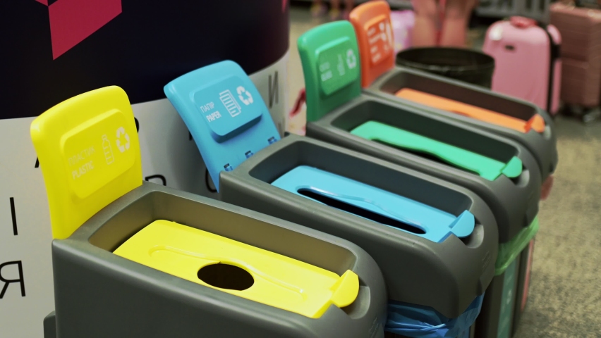Colorful plastic garbage bins with waste recycle logo, Concept of sorting systems and separate garbage, male hand throws out paper, 4 | Shutterstock HD Video #1088723139