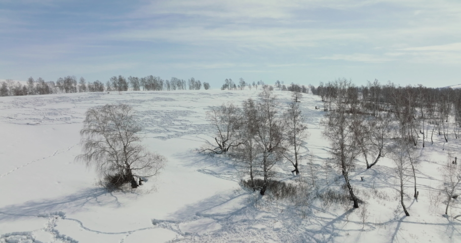 Snow covered hills. South Ural mountains landscapes. Aerial drone view at winter sunny frozen day