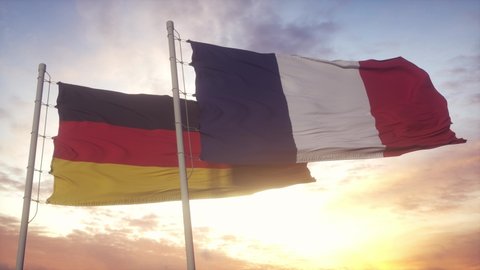 Germany and France flag on flagpole. Germany and France waving flag in wind. Germany and France diplomatic concept