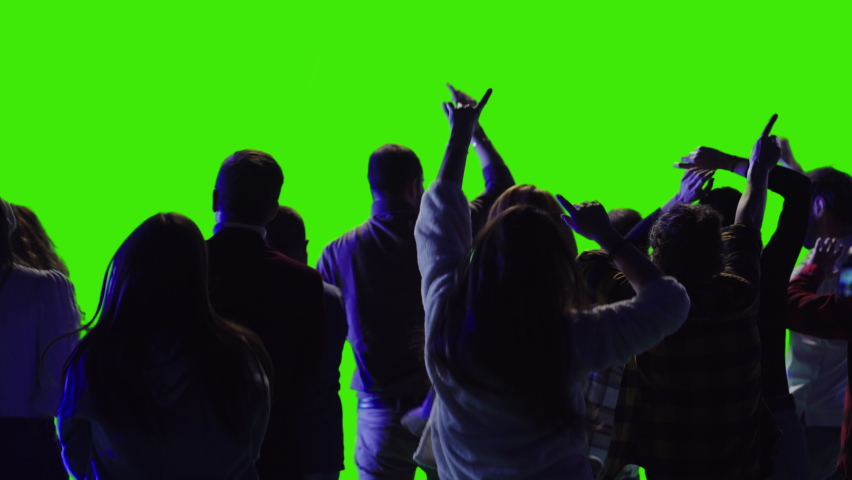 Cheerful people are dancing together. They are enjoying the concert with very loud volume greenscreen Royalty-Free Stock Footage #1088723827