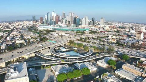 LOS ANGELES, CA, USA - March 15, 2022: Aerial view Los Angeles freeway, cars and trucks on road traffic on highway to downtown LA. urban modern city in USA, travel destination in America. Drone 4k. 