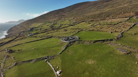 Cashel Murphy, Kerry, Ireland, March 2022. Drone gradually orbits the ancient Celtic settlement at Glanfahan from the southeast with the Blasket Islands in the distance on the Wild Atlantic Way.
