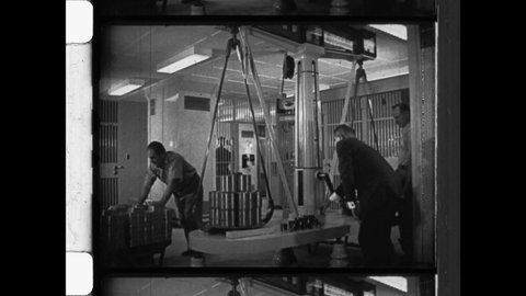 1941 Fort Knox, KY. Men weigh gold bars at The United States Bullion Depository. Using a weight scale with steelyard balance or fulcrum the gold bars are measured by weight. 4K overscan of newsreel 