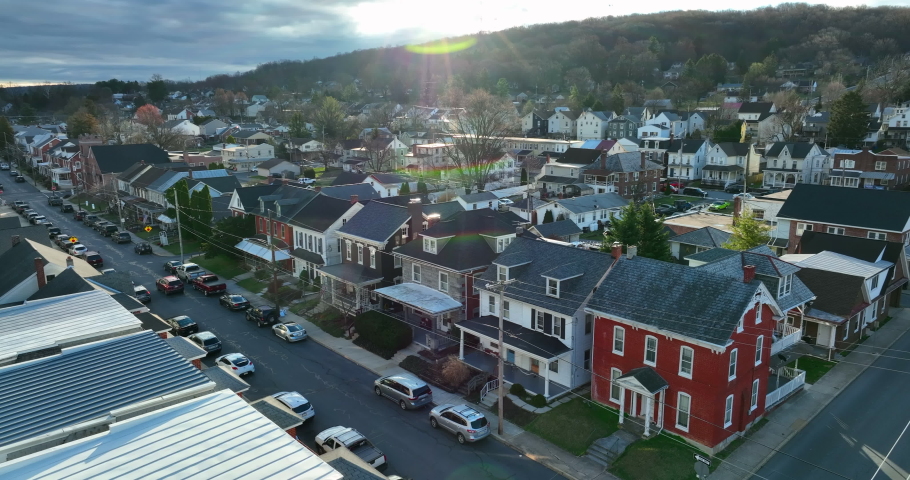 Aerial of homes in small town in USA during winter dramatic light. Beautiful colorful shot.