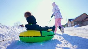 Happy children play with winter skating ring at winter holidays. Two kids having fun in the snow. Healthy lifestyle. - Powered by Shutterstock - Get 15% off with code: PIKWIZARD15