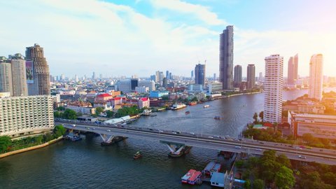 BANGKOK THAILAND - 2022 March 28, 4K UHD : Aerial view over the Chao Phraya River and Buildings of Bangkok City at sunrise. beautiful drone video. Cinematic drone shot.
