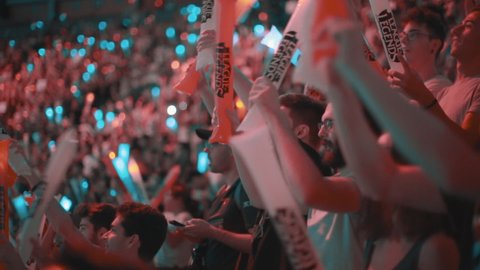 Madrid, Spain; September 9th, 2018. League of Legends Final. Excited gamers using thundersticks to encourage their teams. Crowded stadium.